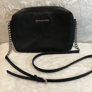 Black Michael Kors cross body purse with silver details and chain